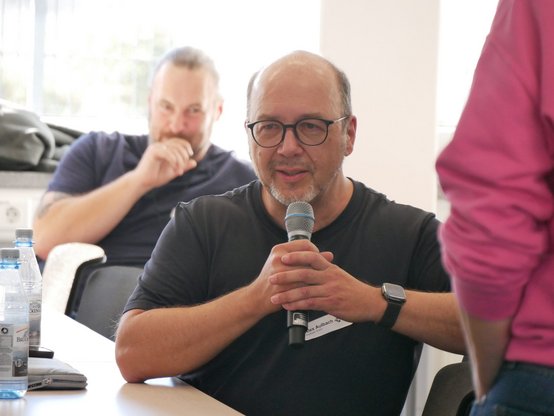 Ein Teilnehmer bringt seine Sicht in die Diskussion ein